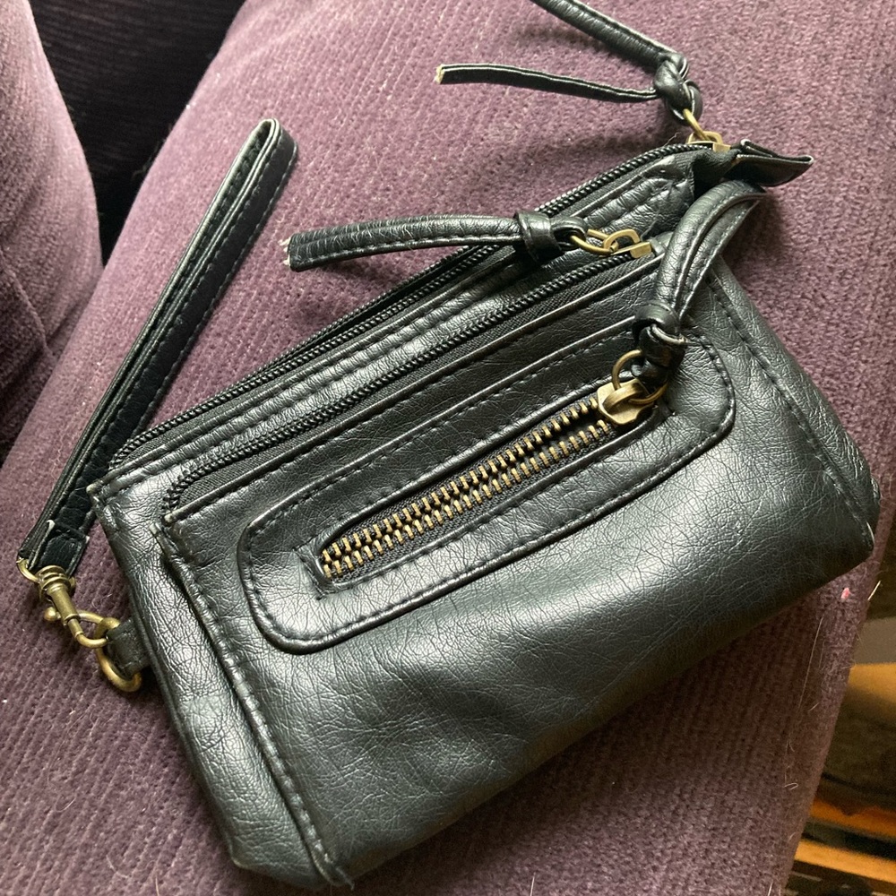 Faux leather wristlet with 3 pockets.